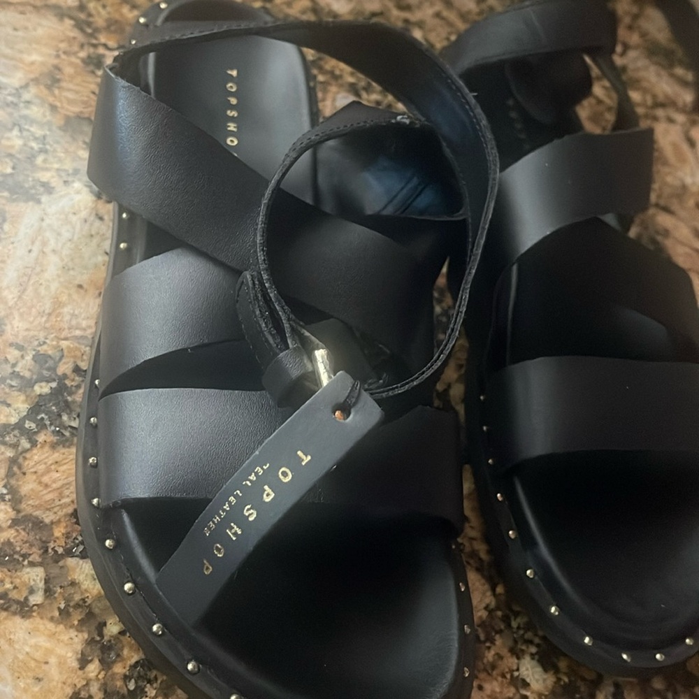 Black leather sandals with gold ball like design.Some tarnish on buckle. Size9.